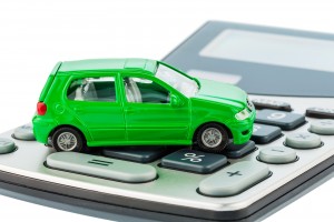 a car is on a calculator. cost of gasoline, wear and insurance.